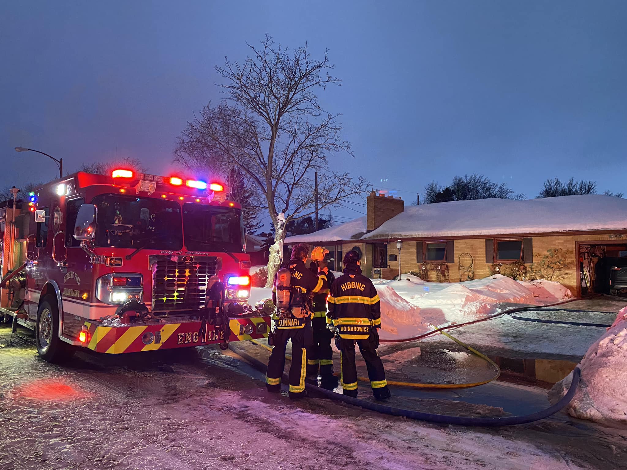 Firefighters operating an Engine at a fire scene