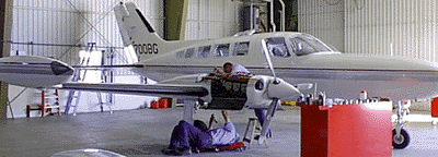 Mechanic working on a prop engine plane